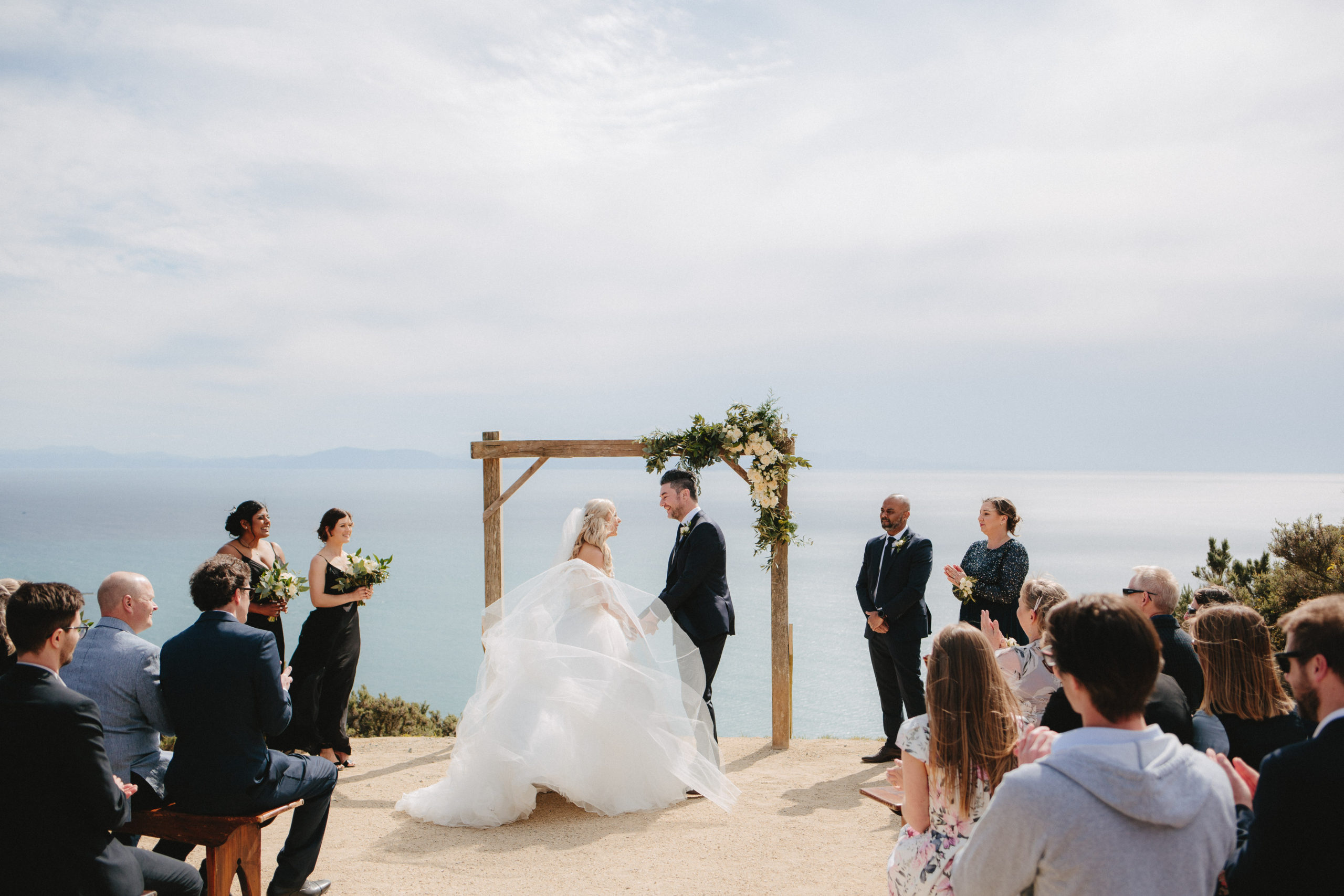 Saying their vows as brides dress catches the wind