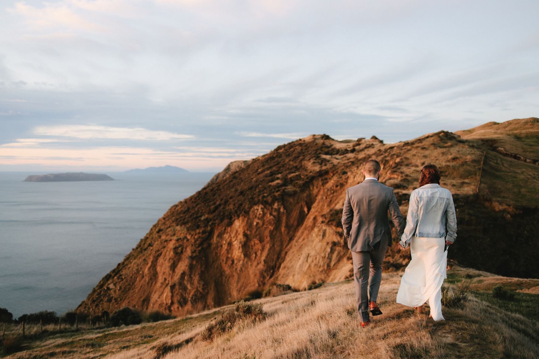 Newlyweds enjoying a walk alng the Boomrock Coastline during sunset